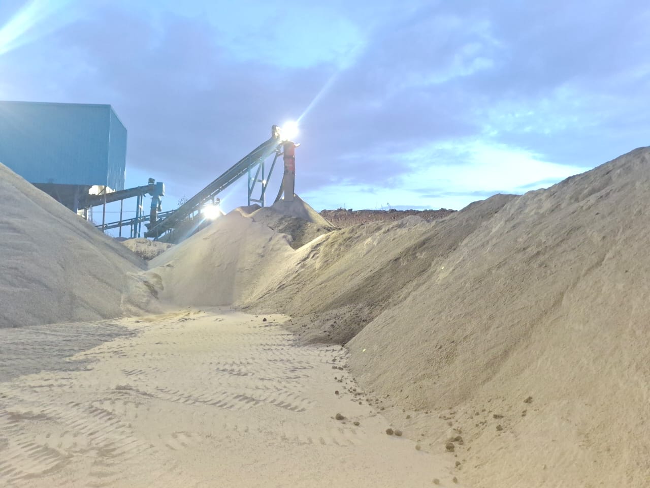 Crusher conveyor and stockpile at dusk