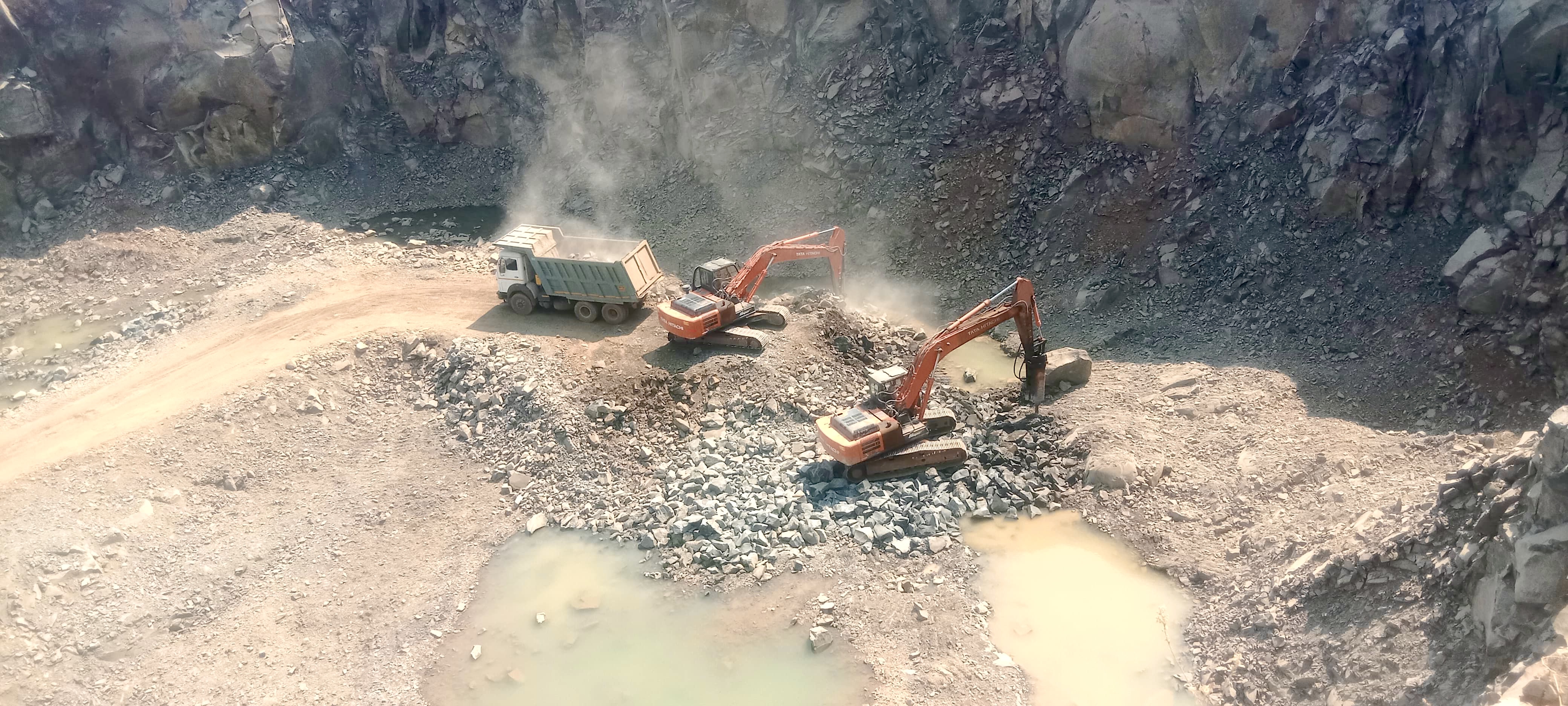 Excavator working through rock dust