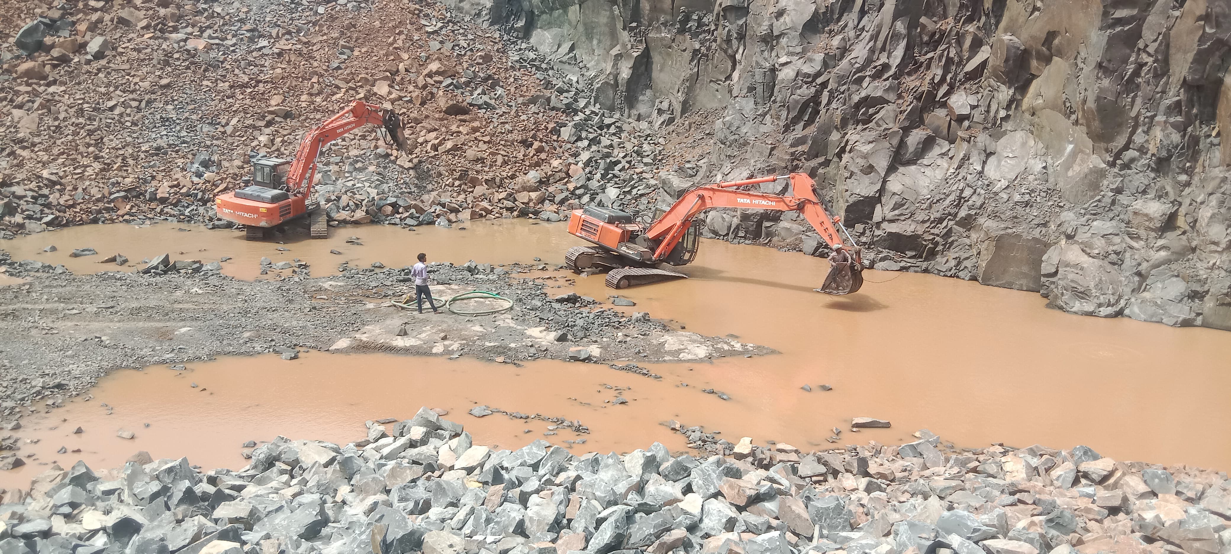 Excavator loading blasted rock